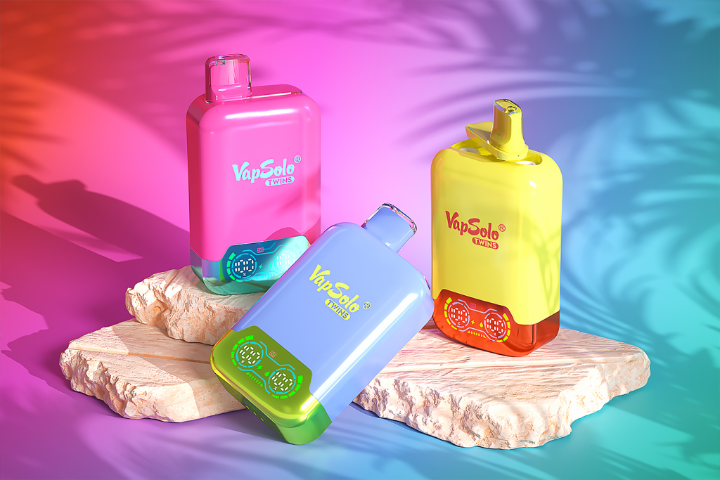 Three VapSolo TWINS vape devices in pink, yellow, and blue are shown. Each device features a rounded design and a digital LED display at the bottom. They are placed on textured stone platforms against a colorful pink and blue gradient background.